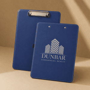 Blue leatherette clipboard with metal clip and custom engraved logo for business, office, or promotional use.