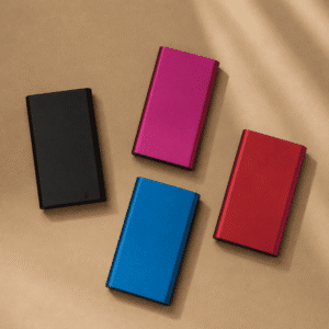 Custom aluminum power bank in multiple colors with personalized logo engraving for portable device charging.