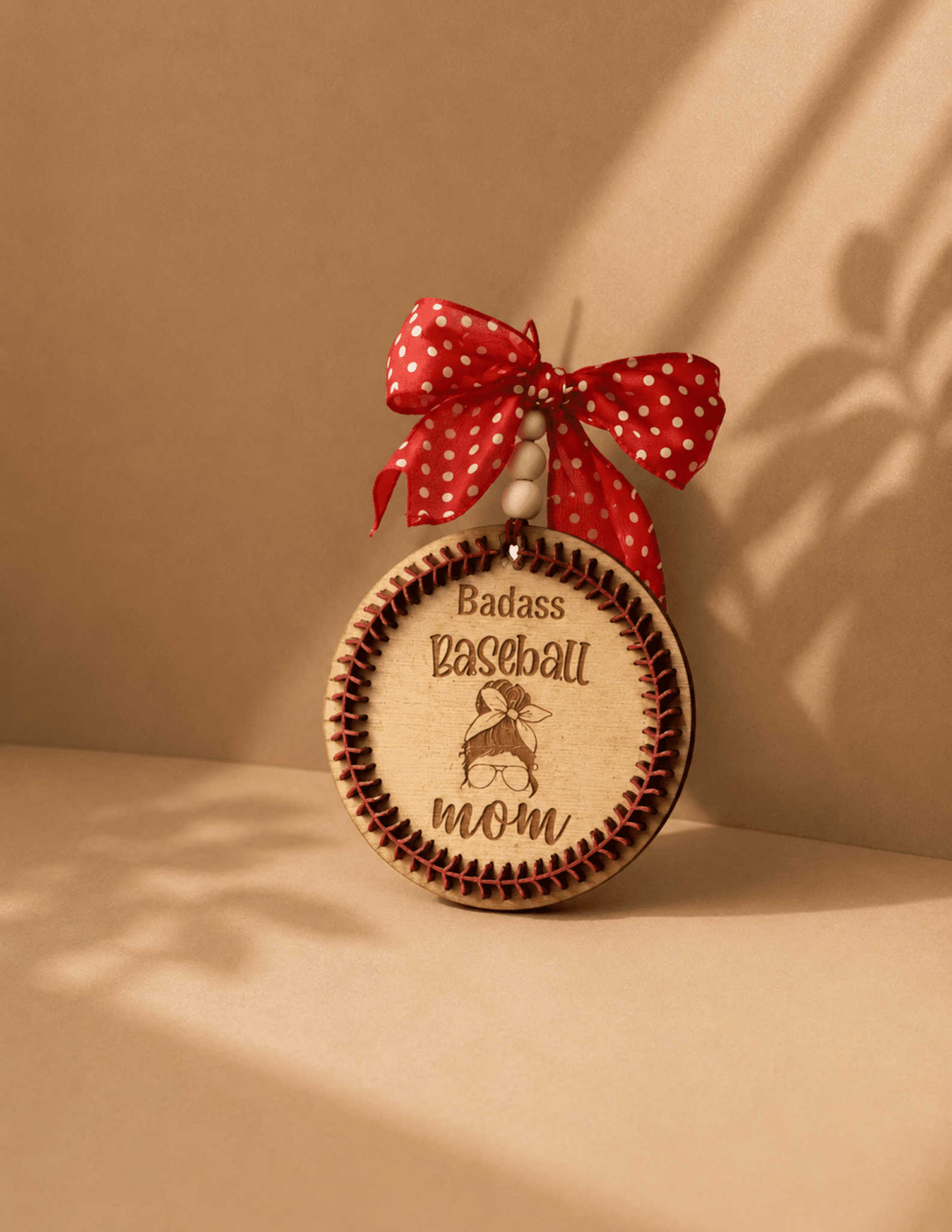 Baseball Themed Car Charm with engraved baseball design, stitched details, wooden beads, and a decorative red polka dot bow.
