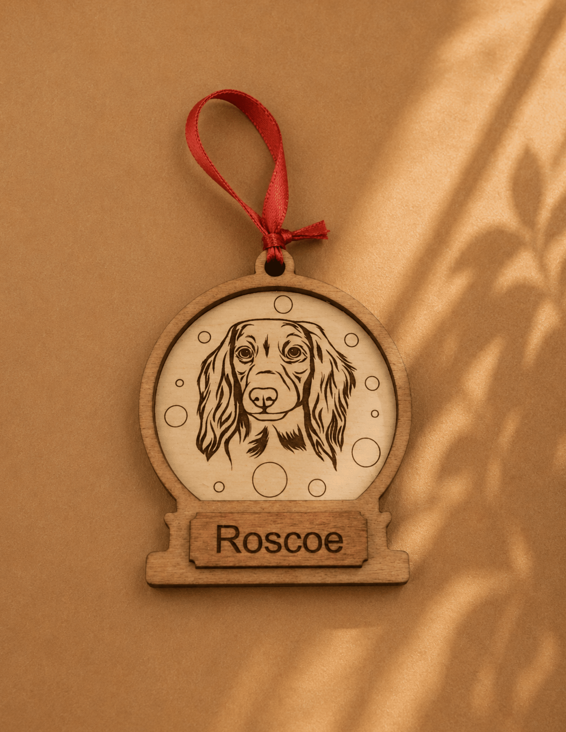 Personalized snow globe pet ornament with engraved pet name and breed for Christmas tree dΓ©cor.