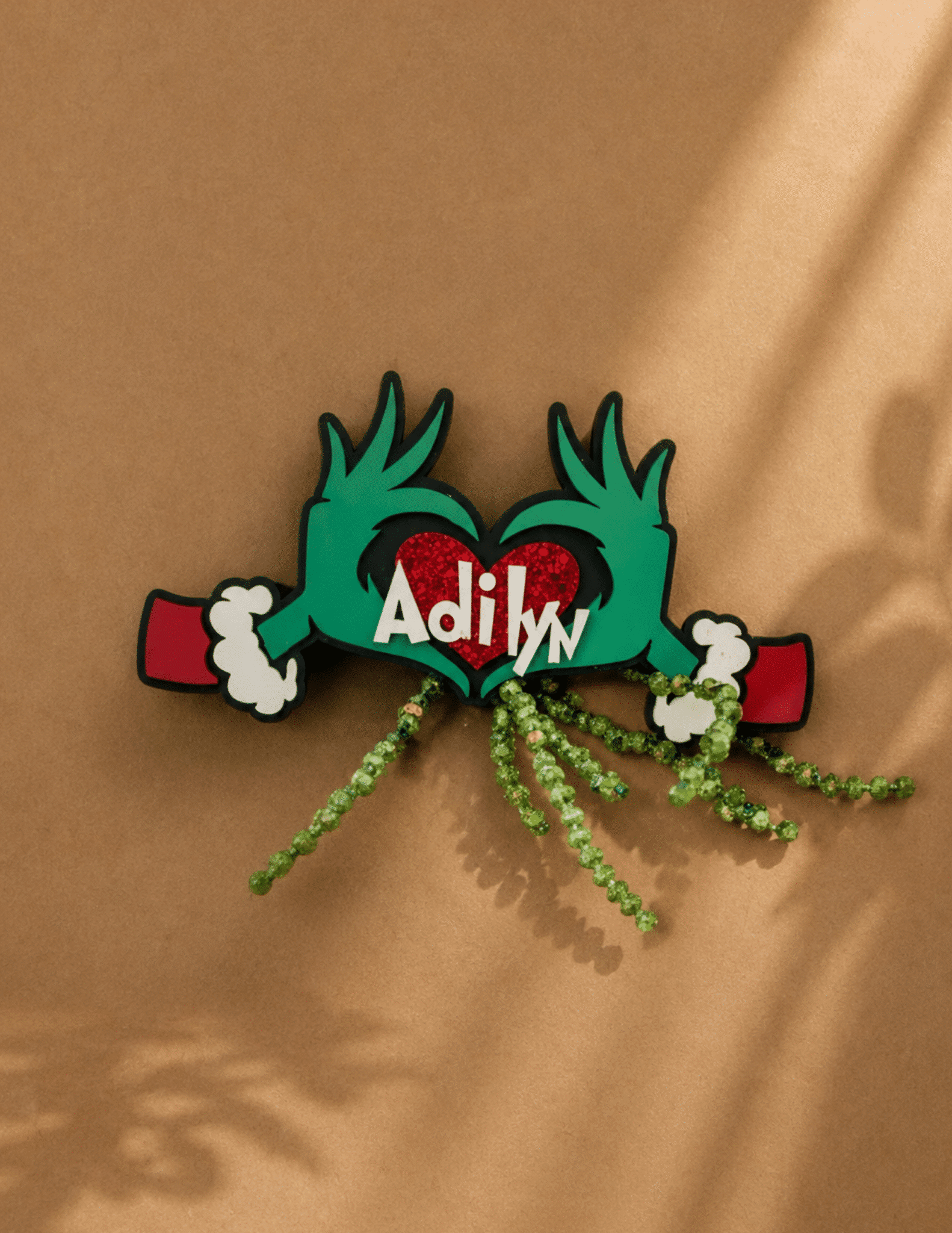 Personalized Grinch themed ornament with heart design and custom name for Christmas tree décor.