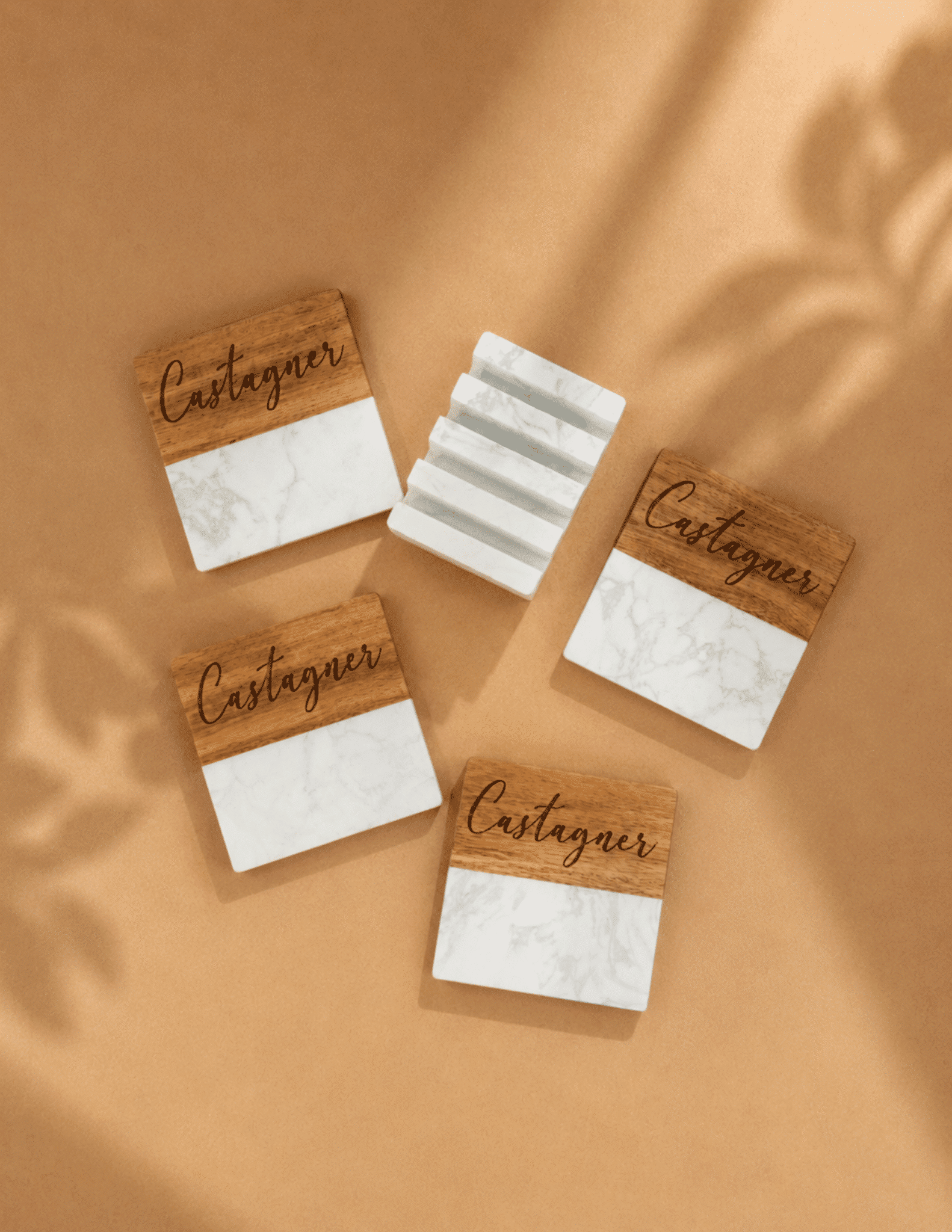 Personalized marble and acacia wood coaster set with engraved design and matching marble holder.