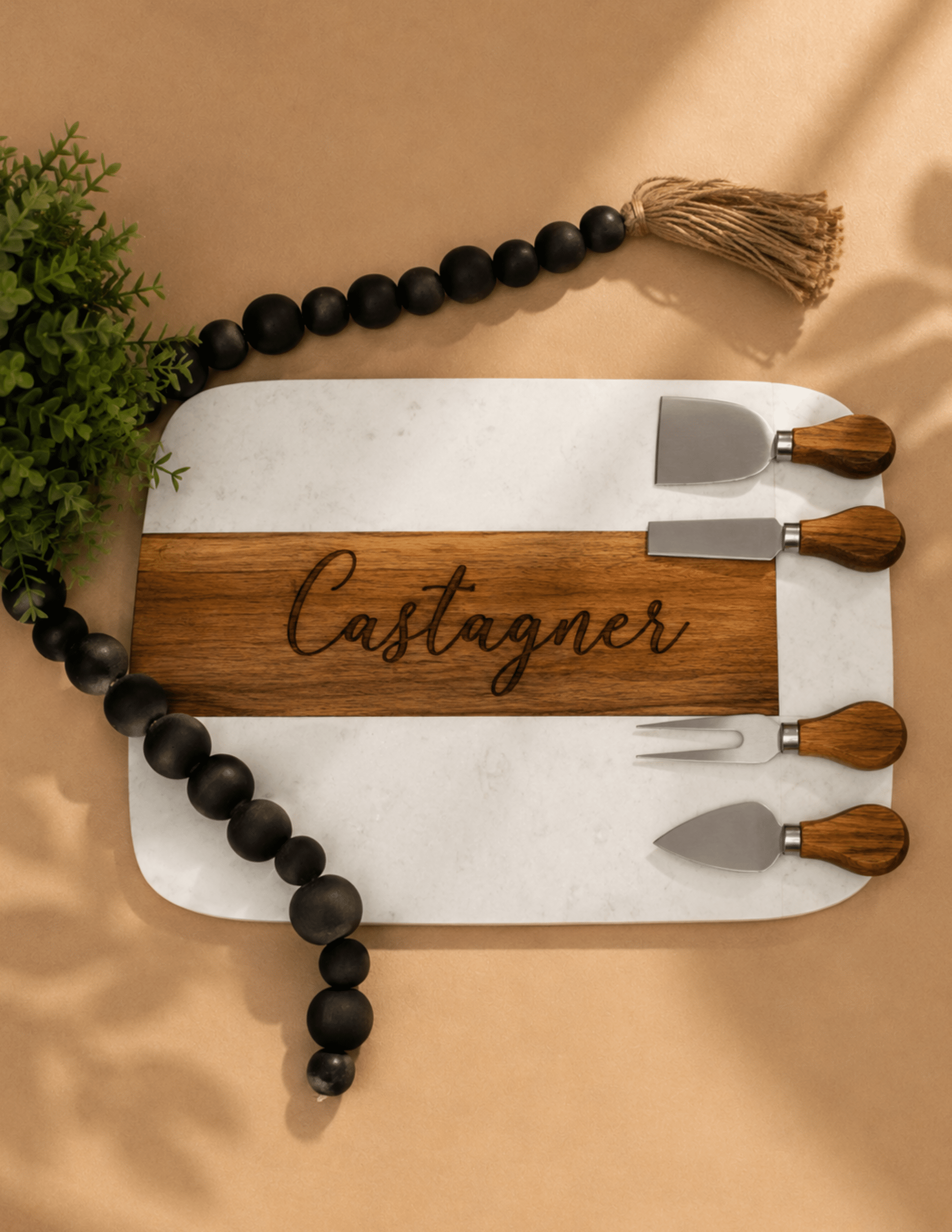 Custom marble and acacia wood cutting board with engraved name and four-piece cheese knife set.