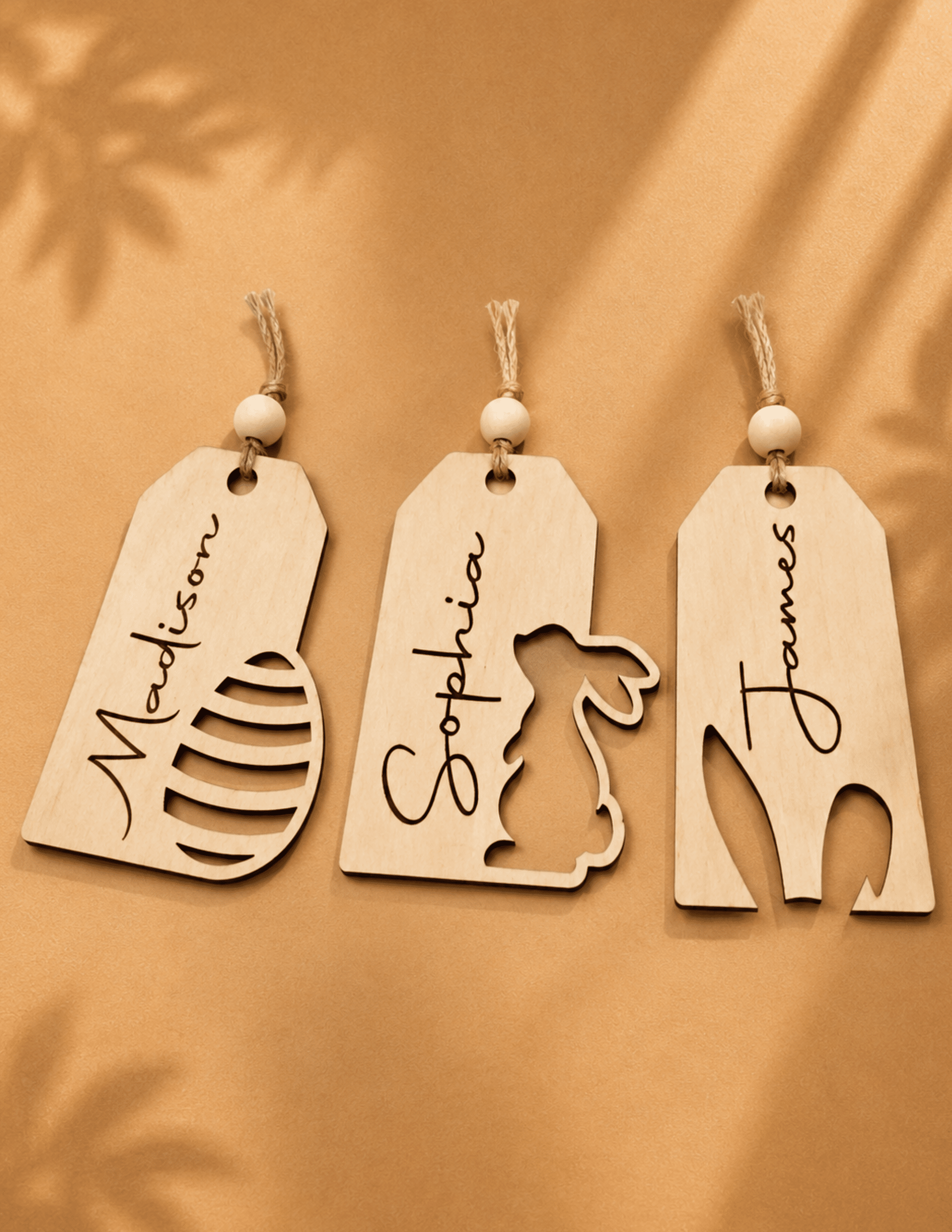 Personalized minimalist wooden Easter basket tags with custom names and decorative cutout designs for Easter baskets.