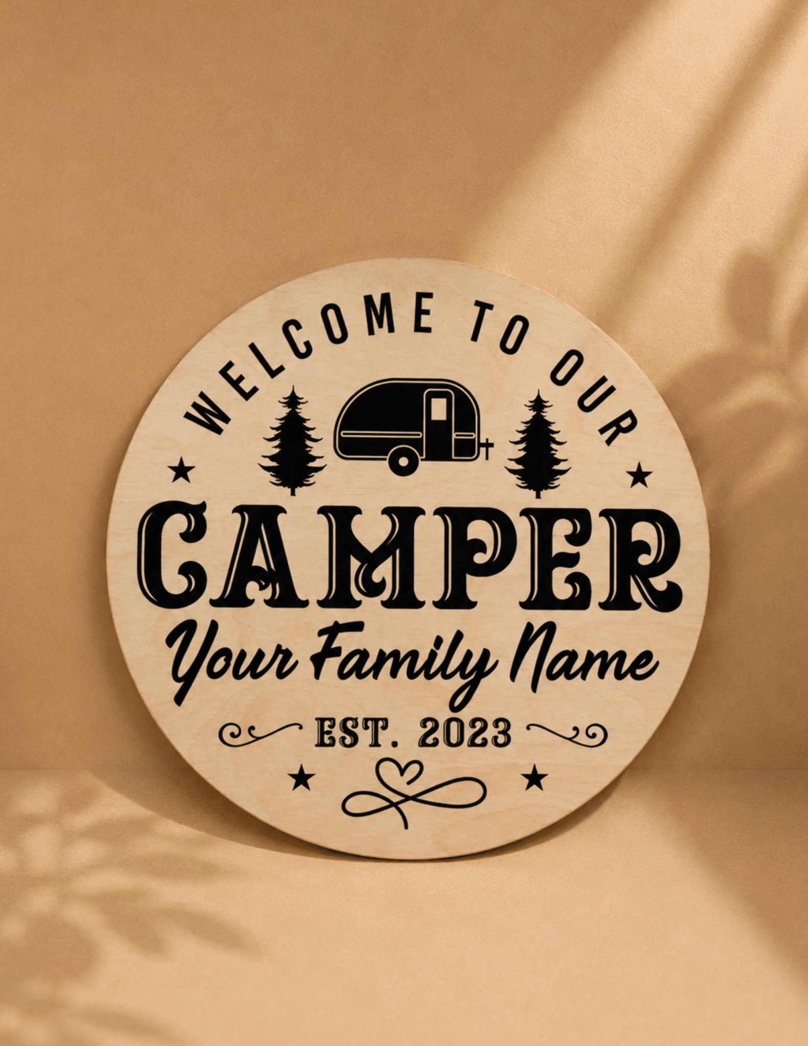 Personalized round wooden camper sign with family name, trailer graphic, and custom established date.