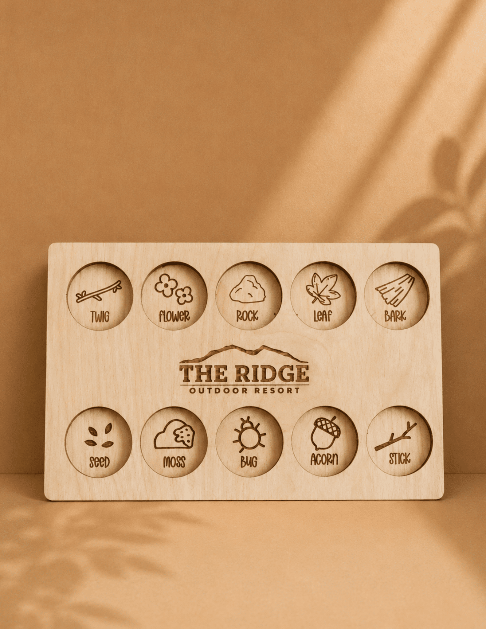 Personalized wooden nature scavenger hunt board with engraved outdoor icons for kids and family adventures.
