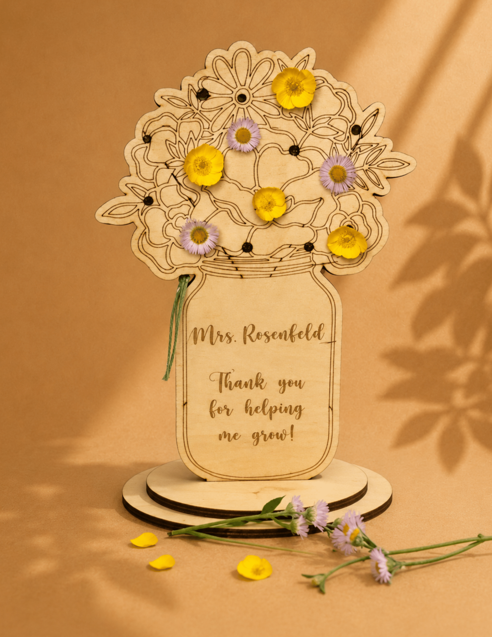 Personalized wooden teacher flower stand with custom name and "Thank You for Helping Me Grow" message holding fresh flowers.