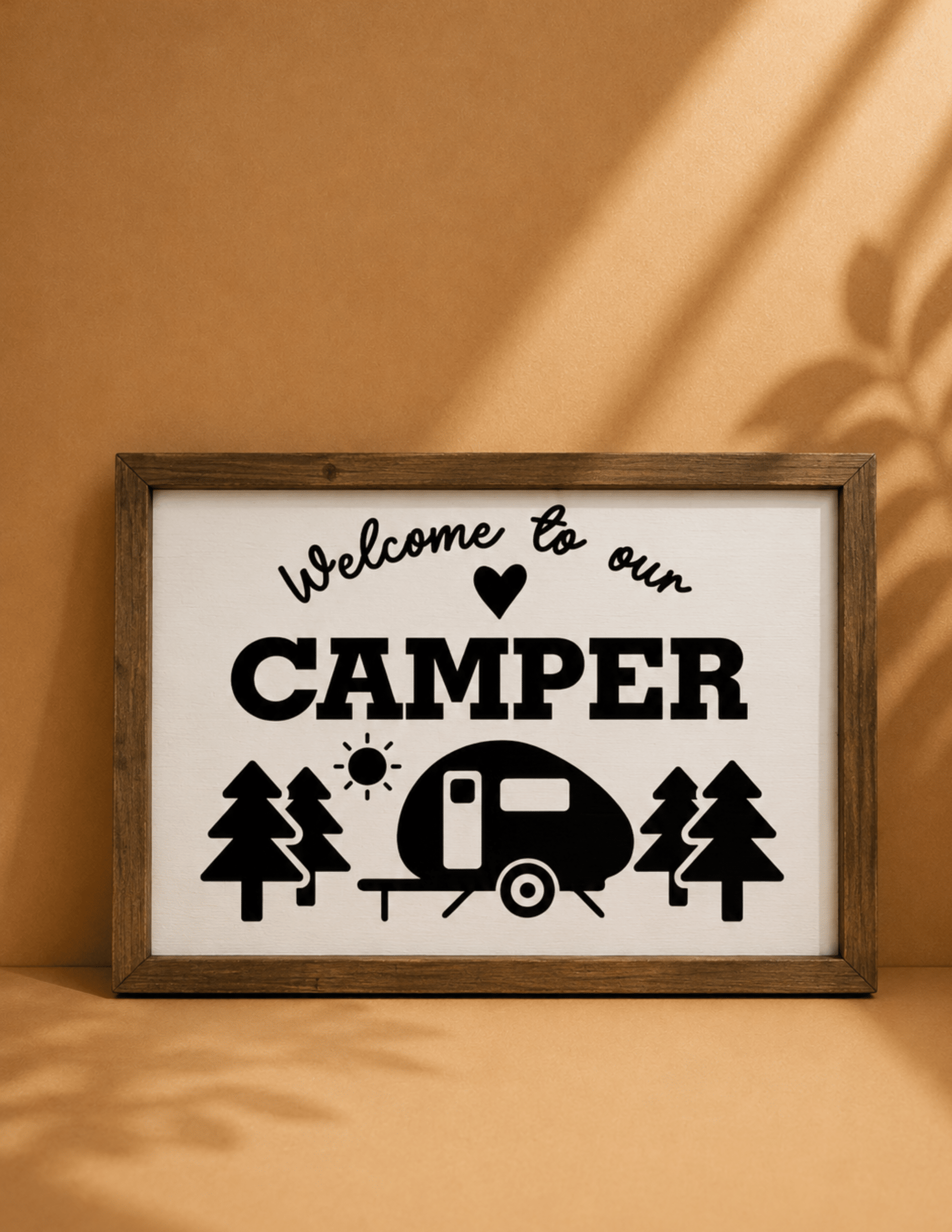 Welcome to Our Camper wall décor with camper trailer, trees, and rustic camping design.