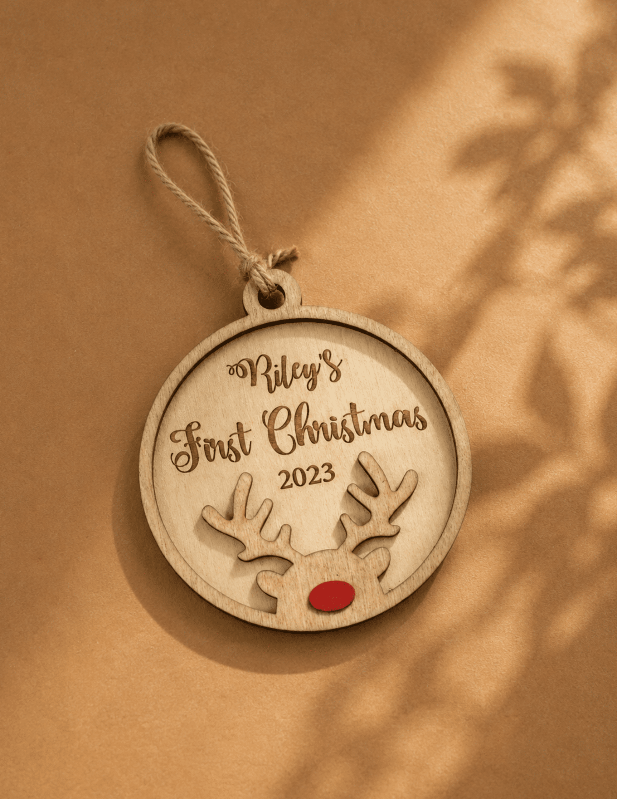 Personalized Baby's First Christmas ornament with custom name, year, and wooden reindeer design.