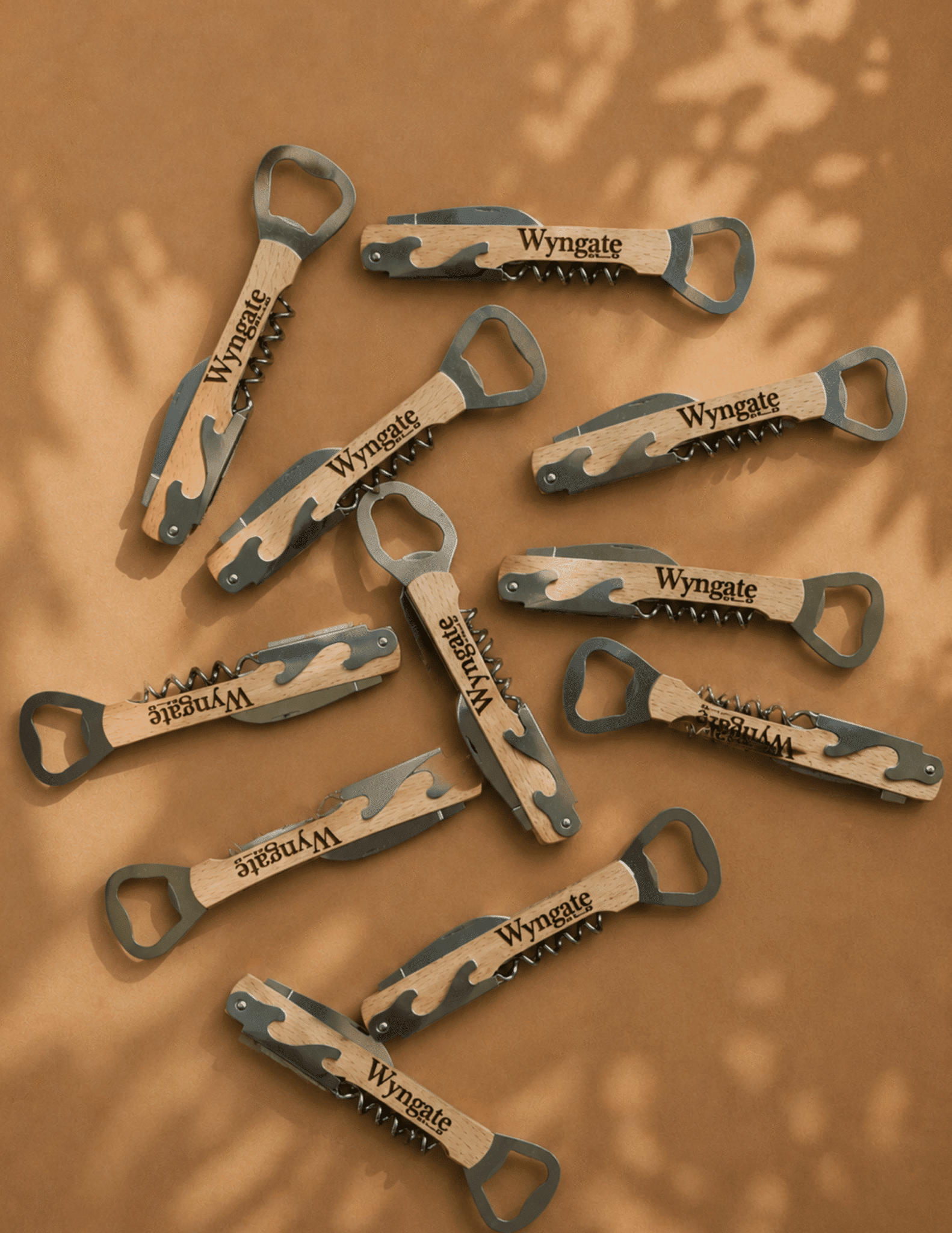Personalized wine bottle opener with engraved wooden handle, corkscrew, and built-in bottle opener.