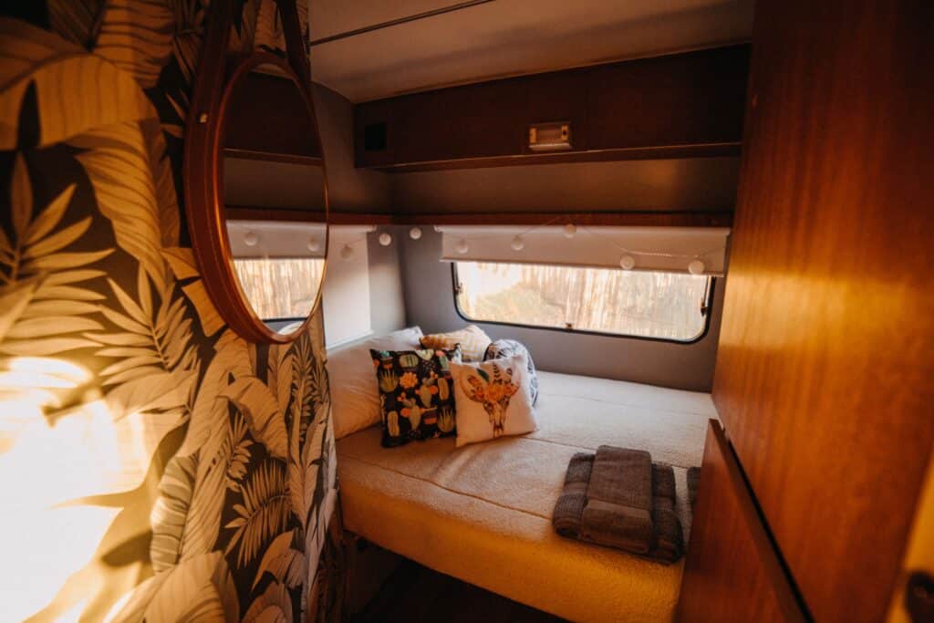 Cozy RV bedroom with personalized decorative pillows
