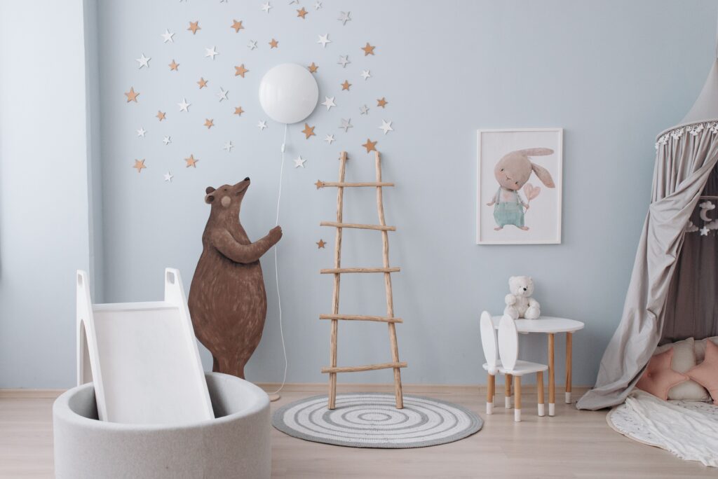 Modern nursery with soft blue walls and woodland decor