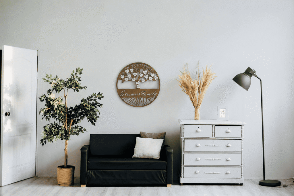Personalized family tree wooden wall decor displayed above a sofa in a modern living room.
