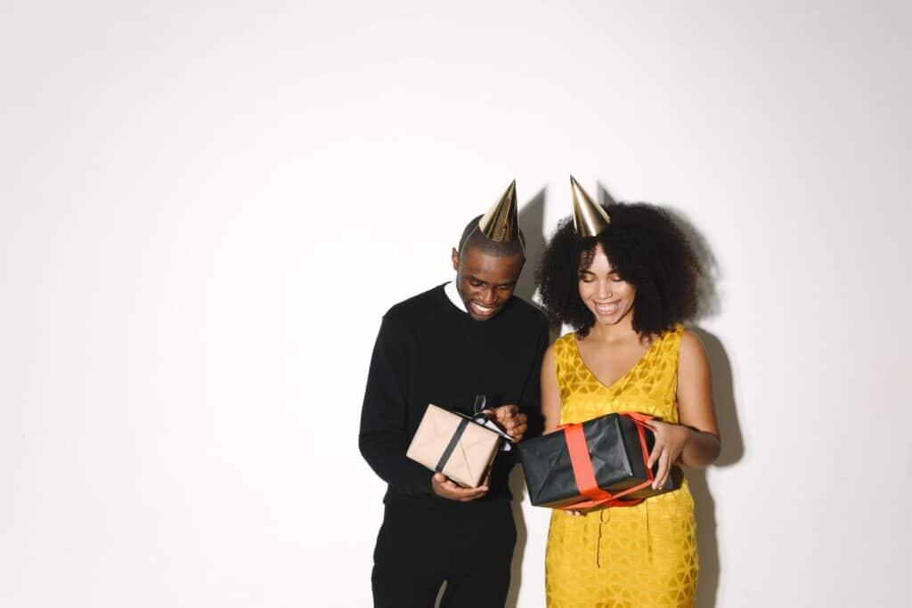 Couple opening wood anniversary gifts together during a celebration